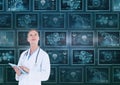 Woman doctor looking up against background with medical interfaces Royalty Free Stock Photo