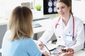 Woman doctor measuring patient blood pressure in clinic Royalty Free Stock Photo