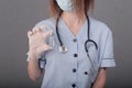 Woman doctor in medical mask and gloves. close-up. holds an ampoule with a vaccine in his hands. covid Royalty Free Stock Photo