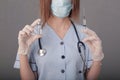 Woman doctor in medical mask and gloves. close-up. holds an ampoule with a vaccine and a syringe in his hands. covid Royalty Free Stock Photo