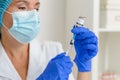A woman doctor or nurse fills a syringe with the Covid-19 coronavirus vaccine, close-up. Royalty Free Stock Photo