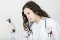 Woman doctor with a otoscope in her hand.