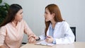 Woman doctor and patient consultation with professional specialist diagnostics at hospital medicare treatment clinic. Doctor writi