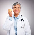 Woman, doctor and portrait with apple in studio for vitamin c benefits, health and care on grey background. Happy mature Royalty Free Stock Photo