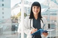 Woman, doctor and portrait smile writing on clipboard by window for healthcare planning, strategy or notes. Female Royalty Free Stock Photo