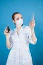 Woman doctor in protective mask against coronavirus on a blue background