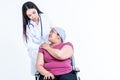 Woman doctor put hand is placed on the shoulders of a female patient Which sat on wheelchair to encourage Royalty Free Stock Photo