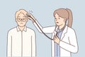 Woman doctor puts stethoscope on patient head for concept of treating headaches or neuro medicine