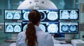 Woman doctor\'s dedicated effort in examining brain scans displayed on multiple screens