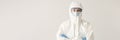 Woman doctor or scientist stands in protective suit, mask and glasses with folded arms on white background Royalty Free Stock Photo