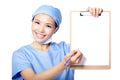 Woman doctor showing empty blank clipboard Royalty Free Stock Photo