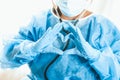 Woman doctor shows heart with hands. Doctor`s love for patients. Doctor for the heart. Concept of Covid-19 quarantine. Medical Royalty Free Stock Photo