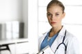 Woman - doctor sitting in clinic. Physician at work, studio portrait. Medicine and health care concept Royalty Free Stock Photo