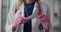 Woman doctor with stethoscope holds transducer in clinic