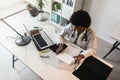 Woman doctor with stethoscope looking at medical papers at her office working hard Royalty Free Stock Photo