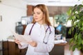 Woman doctor studying clinical diagnosis of patient in medical office Royalty Free Stock Photo