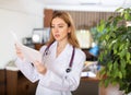 Woman doctor studying clinical diagnosis of patient in medical office Royalty Free Stock Photo