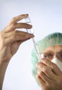 Woman doctor with syringe and medication