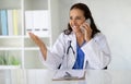 Woman doctor talking on phone, consulting patient Royalty Free Stock Photo