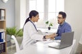 Woman doctor talking to a male patient and giving him a professional medical consultation Royalty Free Stock Photo