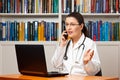 Woman doctor telephone computer talking Royalty Free Stock Photo