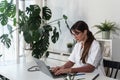 Woman doctor typing on laptop computer while sitting at the desk in hospital office. Female healthcare worker sending email Royalty Free Stock Photo