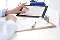 Woman doctor using tablet computer while standing straight in hospital closeup. Healthcare, insurance and medicine Royalty Free Stock Photo