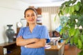 Woman doctor wear white medical uniform and stethoscope look at camera posing in clinic