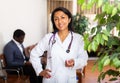 Woman doctor wear white medical uniform and stethoscope look at camera posing in clinic