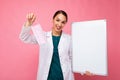 Woman doctor wearing a white medical coat and a mask holding blank board with copy space for text isolated on background Royalty Free Stock Photo