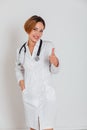 woman doctor in white coat with phonendoscope shows like Royalty Free Stock Photo