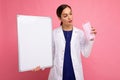 Woman doctor in a white medical coat holding blank board with copy space for text and protective mask isolated on Royalty Free Stock Photo