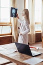 Woman doctor at window looking at skull scan Royalty Free Stock Photo