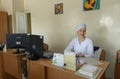 Woman doctor working at laptop in the medical staff room. City children hospital 1. Kyiv, Ukraine