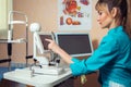 Woman doctor works at the tocuh screen computer in cabinet Royalty Free Stock Photo