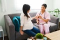 Expectant mother receiving vitamin pills from her nurse Royalty Free Stock Photo