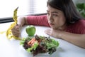 Woman does not want to eat vegetables and she is tired of the diet.