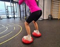 Woman does squats on balance machine Royalty Free Stock Photo