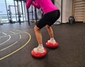 Woman does squats on balance machine Royalty Free Stock Photo