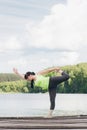 Woman does yoga on the bridge in the summer Royalty Free Stock Photo