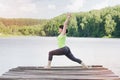 Woman does yoga on the bridge in the summer Royalty Free Stock Photo