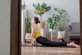 woman does yoga and meditation at home rug in cozy apartment. lady is engaged in physical exercises Royalty Free Stock Photo