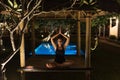 A woman does yoga by the pool. Healthy lifestyle. Body concentration. Meditation by the pool. A woman meditates by the pool. Royalty Free Stock Photo