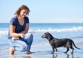 Woman and dog on the beach Royalty Free Stock Photo
