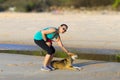 Woman and dog exercise morning at beach