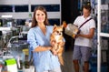 Woman with dog with interest looking at small aquarium Royalty Free Stock Photo