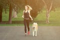 Jogger and akita dog running outdoors