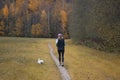 A woman with a dog in the park is running. Sports on the street Royalty Free Stock Photo