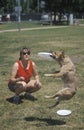 Woman and dog practicing at Canine Frisbee Contest, Westwood, Los Angeles, CA