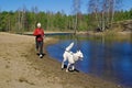 Woman with a dog run along coast of the rivers Royalty Free Stock Photo